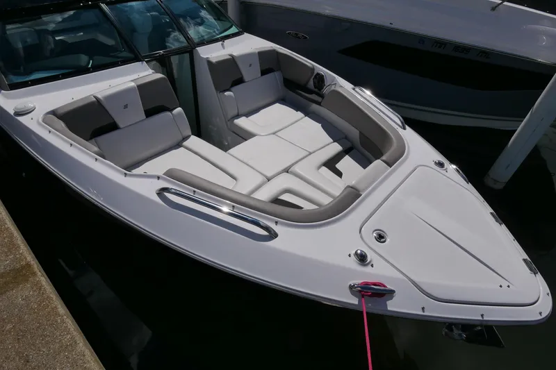 Slide: The Image of 2023 Four Winns H290 boat with spacious seating, docked at marina. - 8