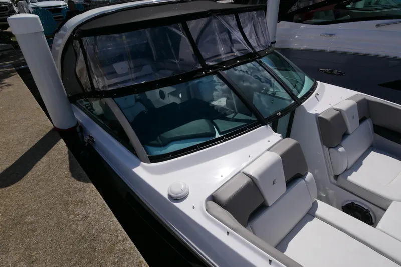 Slide: The Image of 2023 Four Winns H290 boat with sleek design and comfortable seating. - 9