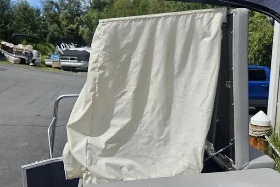 Slide: The Image of 2020 Bennington SXP 21 SLXP boat with a white privacy curtain. - 8