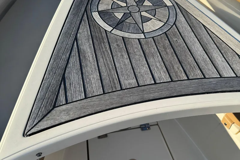 Slide: The Image of 2017 Scout 350 LXF boat seating with storage compartments and cup holders. - 10