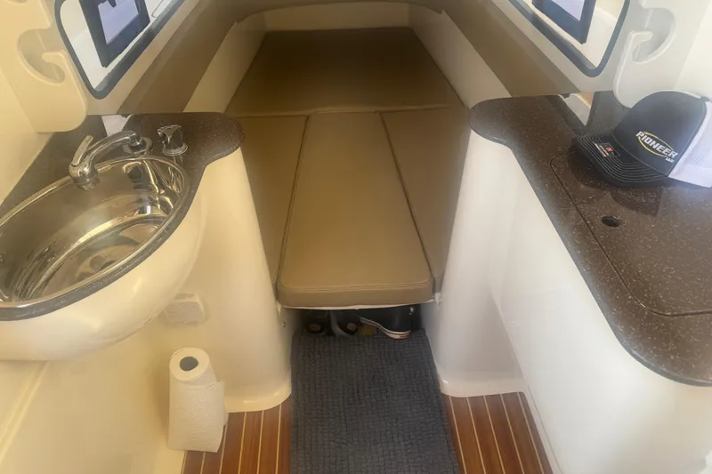 Slide: The Image of Open hatch on 2017 Scout 350 LXF boat, revealing internal storage compartment. - 11