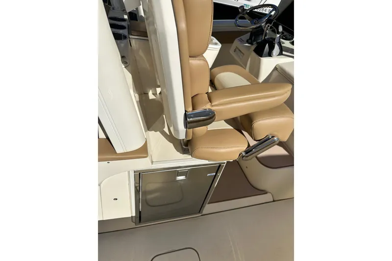 Slide: The Image of 2017 Scout 350 LXF boat interior with tan seating and control panel. - 14