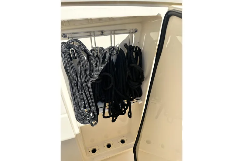 Slide: The Image of Storage compartment with ropes on a 2017 Scout 350 LXF boat. - 17