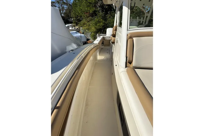 Slide: The Image of 2017 Scout 350 LXF boat interior with beige seating and sleek design. - 19