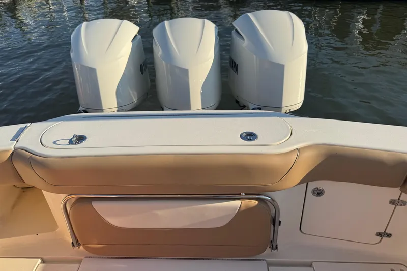 Slide: The Image of 2017 Scout 350 LXF boat with Yamaha engine on trailer, under clear blue sky. - 2