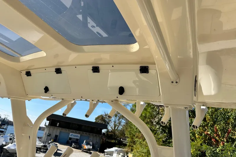 Slide: The Image of 2017 Scout 350 LXF boat interior with rod holders and storage compartments. - 20