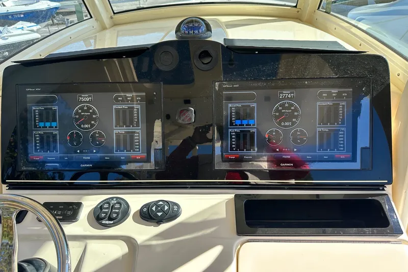 Slide: The Image of Dashboard of a 2017 Scout 350 LXF boat with dual Garmin displays. - 23