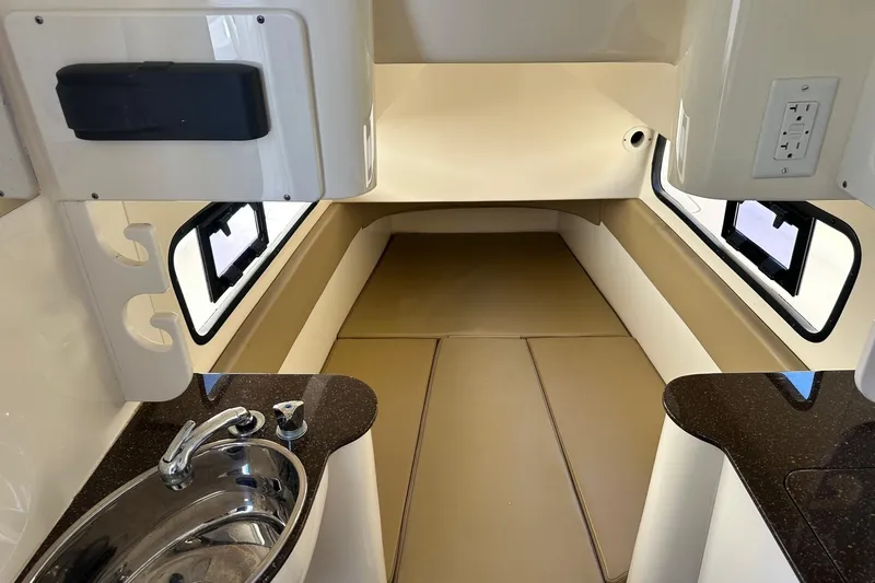 Slide: The Image of 2017 Scout 350 LXF cabin interior with sink and cushioned seating area. - 34