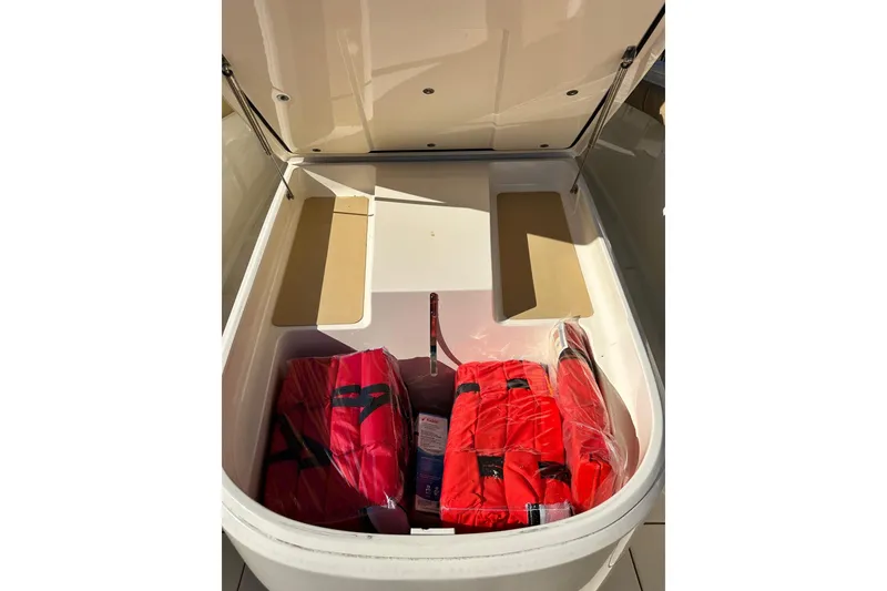 Slide: The Image of Storage compartment of 2017 Scout 350 LXF boat with red life jackets. - 38
