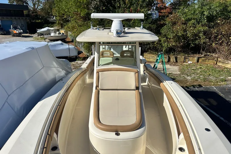 Slide: The Image of 2017 Scout 350 LXF boat with beige seating, docked outdoors. - 40