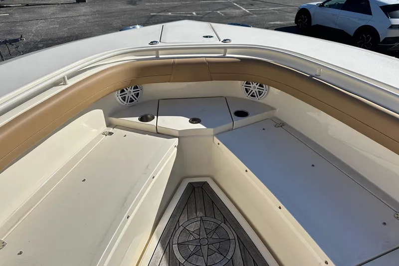 Slide: The Image of 2017 Scout 350 LXF boat interior with tan seating and wood-patterned flooring. - 41