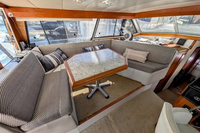 Slide: The Image of Interior of 1989 Bayliner 3888 Motoryacht with cozy seating and table. - 12