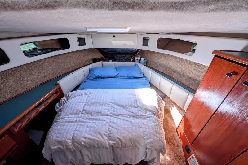 Slide: The Image of Cozy bedroom interior of 1989 Bayliner 3888 Motoryacht with bed and wooden cabinetry. - 16