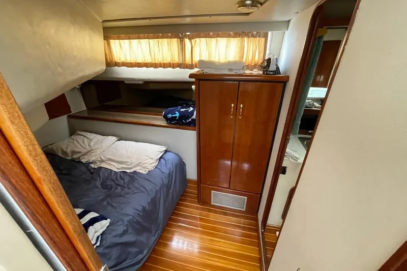 Slide: The Image of Cozy cabin interior of 1989 Bayliner 3888 Motoryacht with bed and wooden cabinetry. - 18