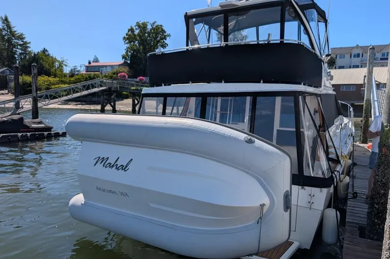 Slide: The Image of 1989 Bayliner 3888 Motoryacht docked in Anacortes, WA, with inflatable boat attached. - 21