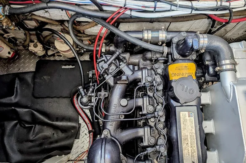 Slide: The Image of Engine compartment of a 1989 Bayliner 3888 Motoryacht, showcasing detailed mechanical components. - 26