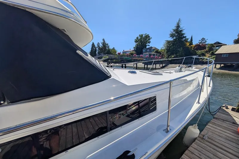 Slide: The Image of 1989 Bayliner 3888 Motoryacht docked, showcasing sleek design and waterfront setting. - 5