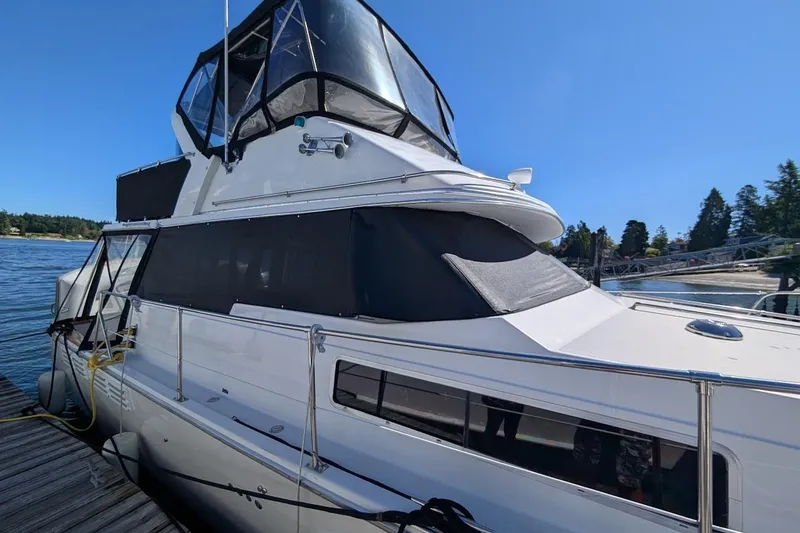 Slide: The Image of 1989 Bayliner 3888 Motoryacht docked, featuring sleek design and spacious upper deck. - 8