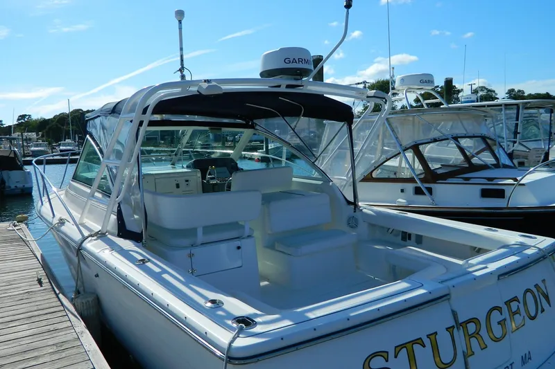 Slide: The Image of 1999 Tiara Yachts 2900 Coronet docked, featuring open cockpit and Garmin radar. - 15
