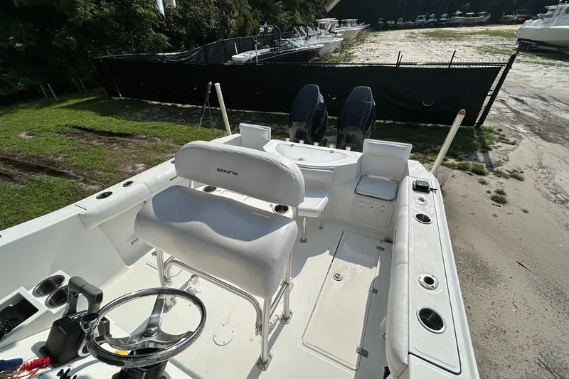 Slide: The Image of 2008 Sea Fox 256 Commander boat interior with dual engines and seating. - 4