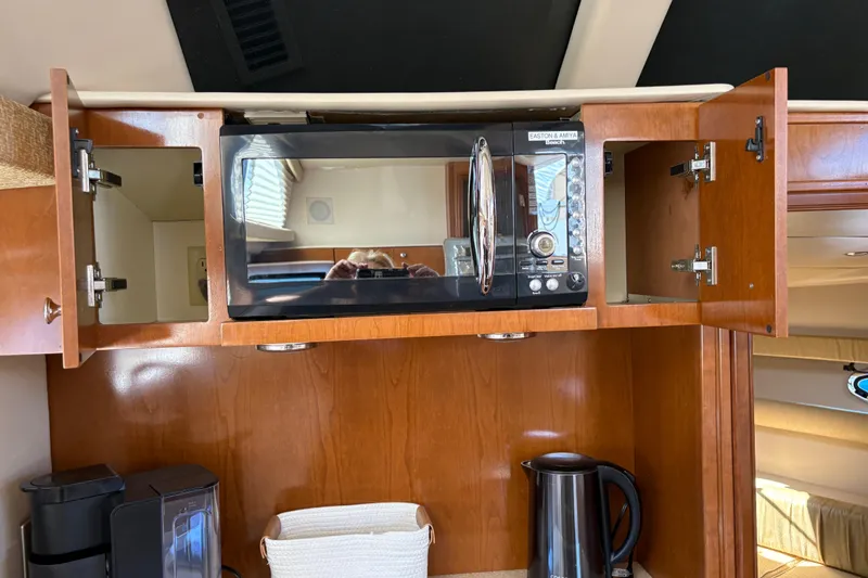 Slide: The Image of 2005 Meridian 368 Motoryacht kitchen with microwave, open cabinets, and appliances. - 24