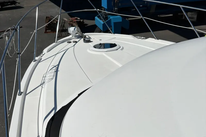 Slide: The Image of 2005 Meridian 368 Motoryacht deck with railing and hatch, in a marina setting. - 10