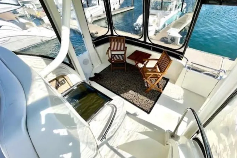 Slide: The Image of 2005 Meridian 368 Motoryacht interior with seating area and marina view. - 13