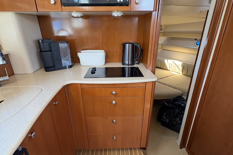 Slide: The Image of 2005 Meridian 368 Motoryacht kitchen with stove, kettle, and cozy cabin view. - 18