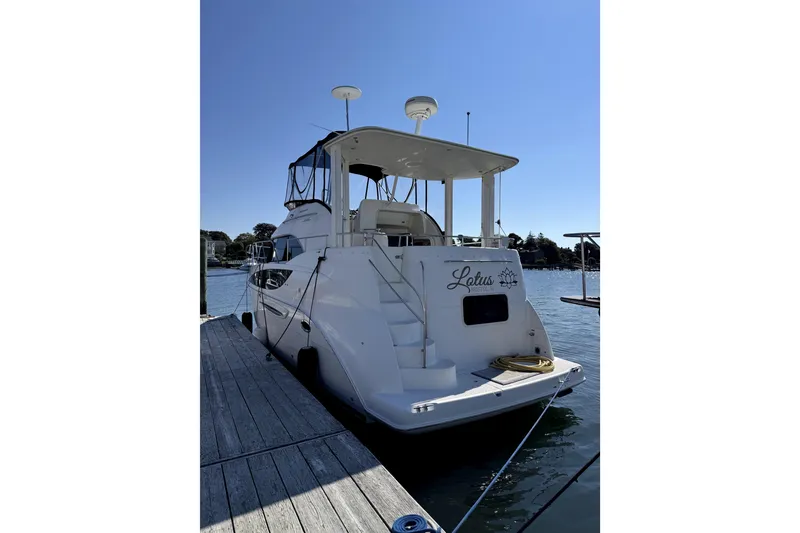 Slide: The Image of 2005 Meridian 368 Motoryacht docked at marina under clear blue sky. - 2