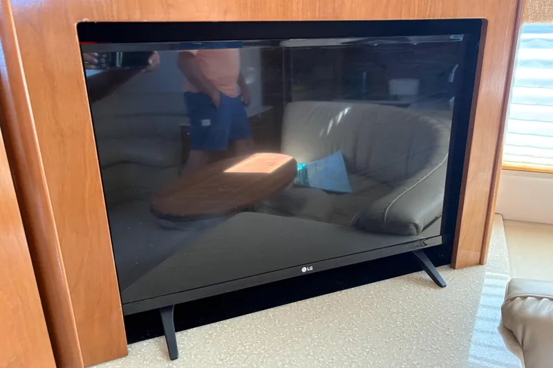Slide: The Image of LG TV inside 2005 Meridian 368 Motoryacht, reflecting interior seating and table. - 29