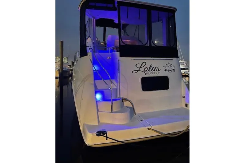 Slide: The Image of 2005 Meridian 368 Motoryacht with blue lights, docked at night. - 3