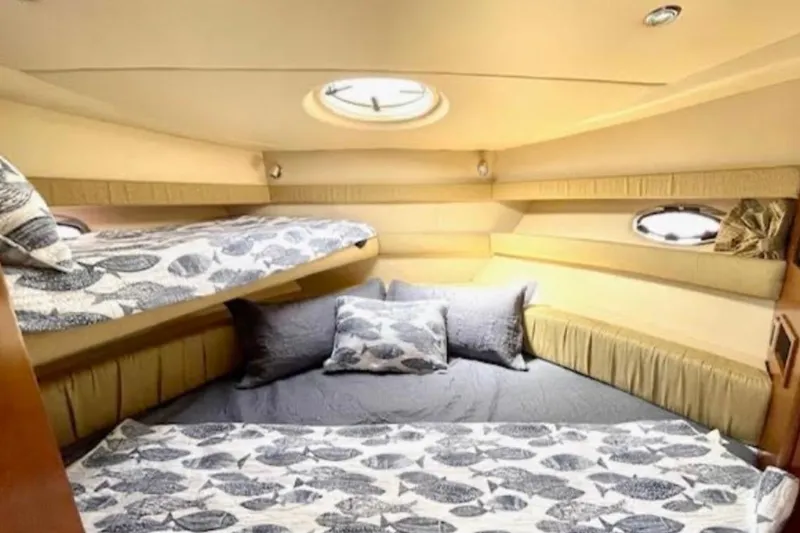 Slide: The Image of Cozy bedroom in 2005 Meridian 368 Motoryacht with patterned bedding and porthole window. - 31