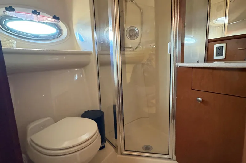 Slide: The Image of Bathroom interior of 2005 Meridian 368 Motoryacht with shower, toilet, and wooden cabinetry. - 36
