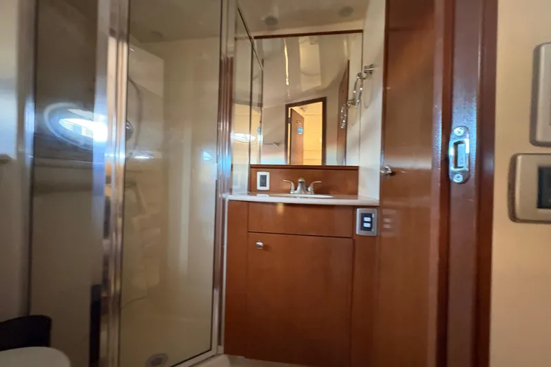 Slide: The Image of 2005 Meridian 368 Motoryacht bathroom with wood cabinetry and glass shower. - 38