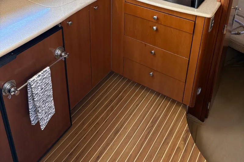 Slide: The Image of 2005 Meridian 368 Motoryacht interior with wooden cabinets and striped flooring. - 19