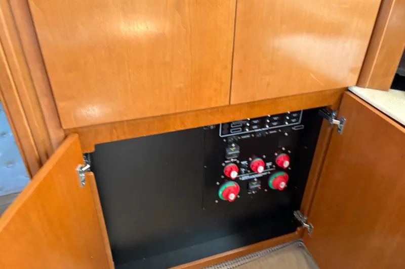 Slide: The Image of Electrical panel inside 2005 Meridian 368 Motoryacht with wooden cabinet doors open. - 49