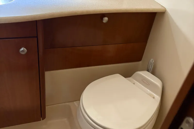 Slide: The Image of 2005 Meridian 368 Motoryacht bathroom with wooden cabinetry and compact toilet. - 57