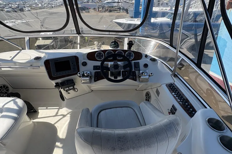 Slide: The Image of 2005 Meridian 368 Motoryacht helm with steering wheel, controls, and navigation equipment. - 61