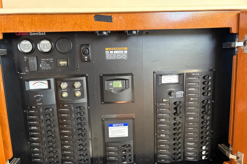 Slide: The Image of Electrical control panel of a 2005 Meridian 368 Motoryacht, featuring Onan GenSet gauges and switches. - 46
