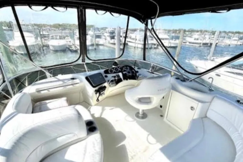 Slide: The Image of 2005 Meridian 368 Motoryacht cockpit with white seating and marina view. - 62