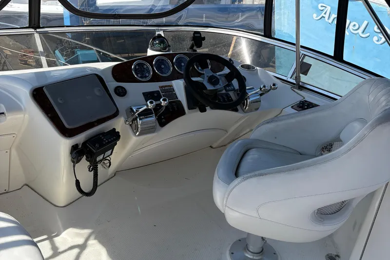 Slide: The Image of 2005 Meridian 368 Motoryacht helm with steering wheel, controls, and captain's chair. - 63