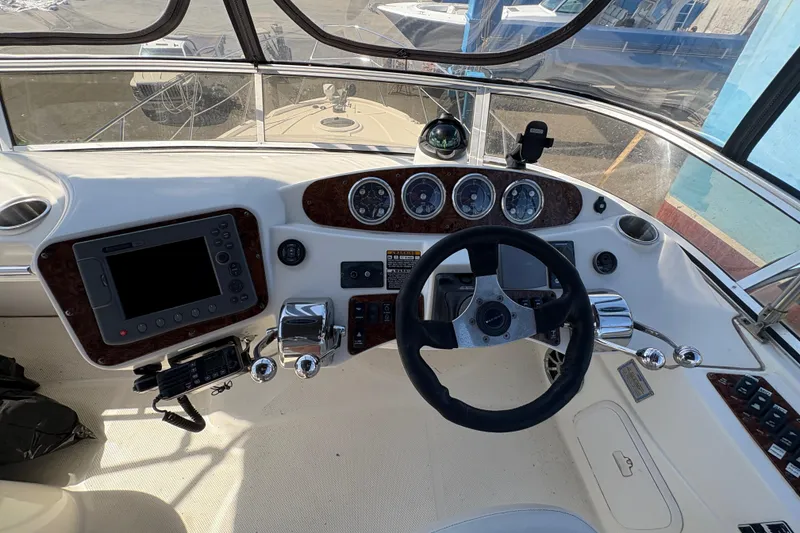 Slide: The Image of 2005 Meridian 368 Motoryacht helm with steering wheel, gauges, and navigation equipment. - 66
