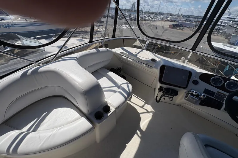 Slide: The Image of 2005 Meridian 368 Motoryacht helm with white seating and navigation controls. - 67