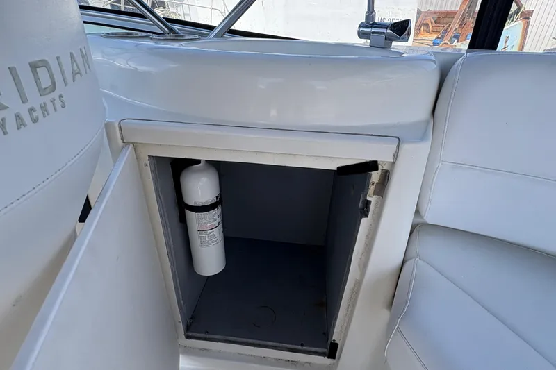 Slide: The Image of Open storage compartment on 2005 Meridian 368 Motoryacht with fire extinguisher inside. - 69