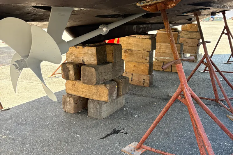 Slide: The Image of 2005 Meridian 368 Motoryacht propeller and hull supported by blocks and stands. - 78