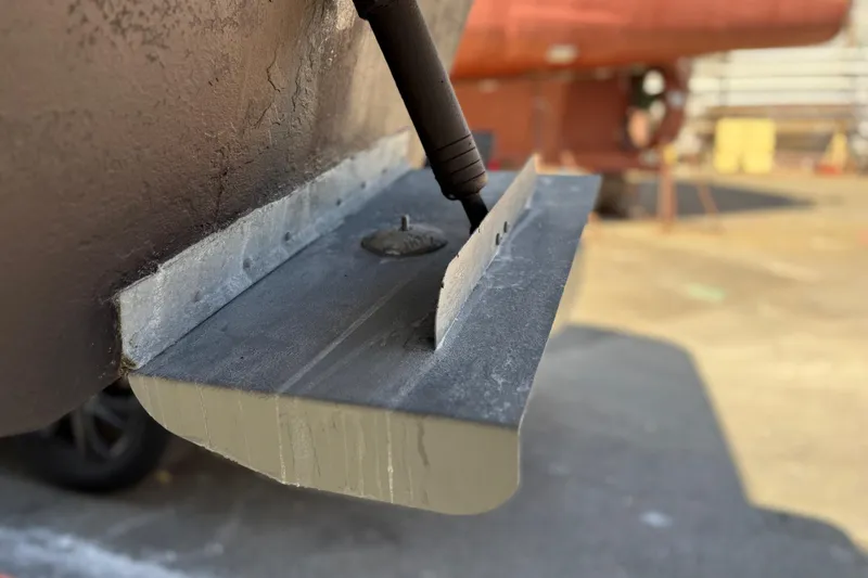 Slide: The Image of Close-up of a 2005 Meridian 368 Motoryacht trim tab in a shipyard. - 79