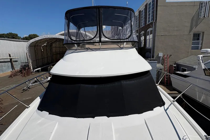 Slide: The Image of 2005 Meridian 368 Motoryacht docked, featuring sleek design and spacious upper deck. - 8