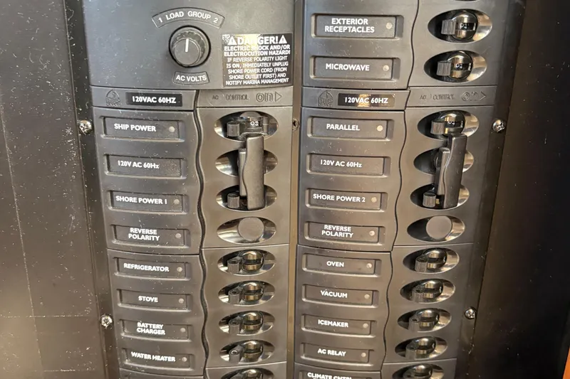 Slide: The Image of Electrical panel of a 2005 Meridian 368 Motoryacht with labeled switches and controls. - 43