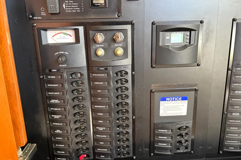 Slide: The Image of Electrical control panel of a 2005 Meridian 368 Motoryacht, featuring switches and monitors. - 47