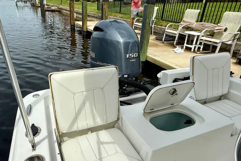 Slide: The Image of 2019 Sea Hunt BX 20 BR boat with Yamaha 150 engine docked by waterfront. - 10